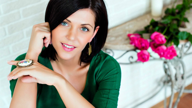 Woman smiling green shirt watch free wallpaper - medium preview image