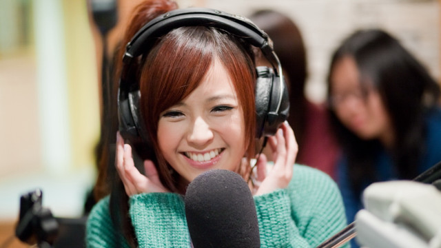 Smiling asian woman headphones green free wallpaper - medium preview image