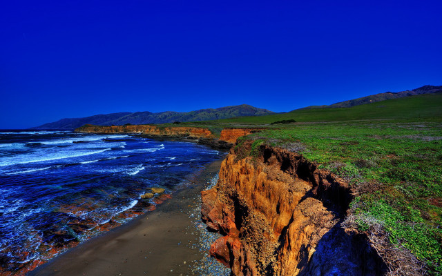 Cliff beach grassy watercity sky free wallpaper - medium preview image