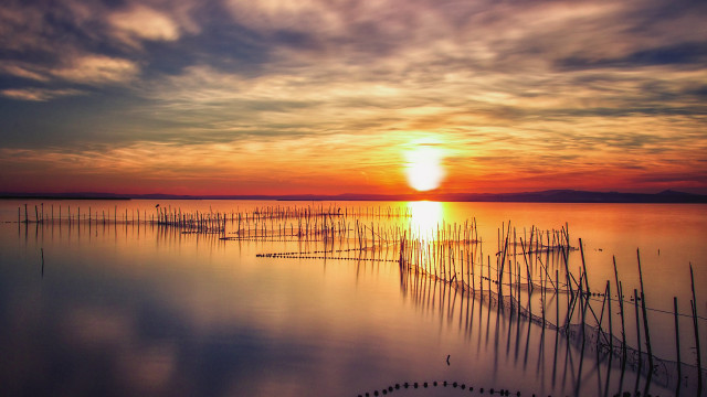 Sunset water poles boats crepuscular free wallpaper - medium preview image