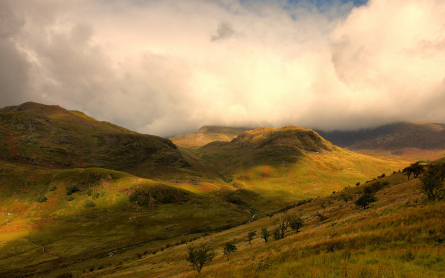Grassy field mountains cloudy sky #2 free wallpaper - medium preview image