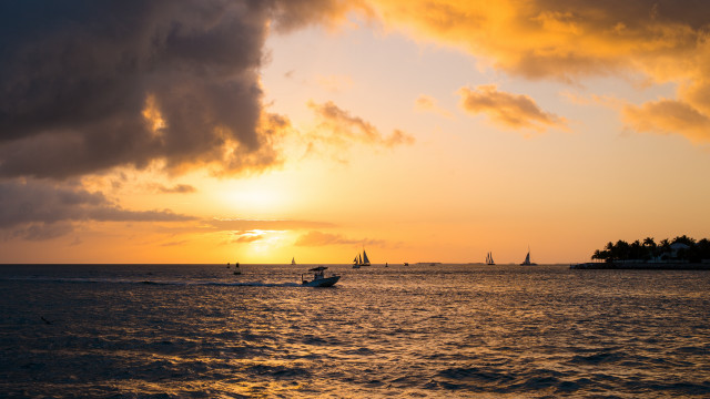 Boat sunset clouds island water free wallpaper - medium preview image
