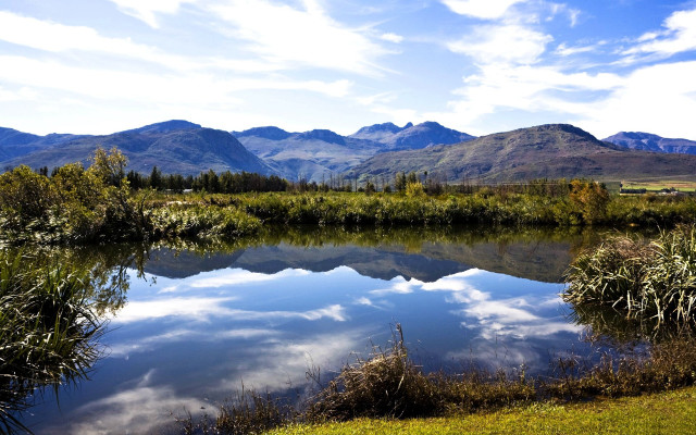 Lake mountains grass clouds sky free wallpaper - medium preview image