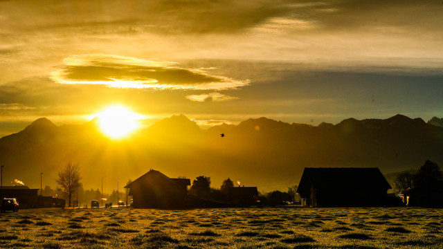 Sunset field houses mountains bird free wallpaper - medium preview image