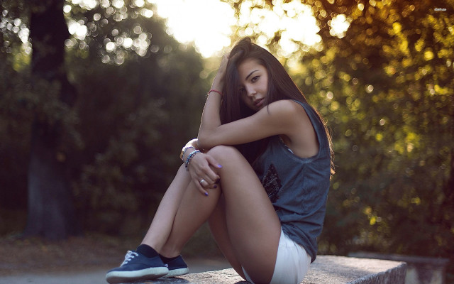 Woman sitting park bench crossed free wallpaper - medium preview image