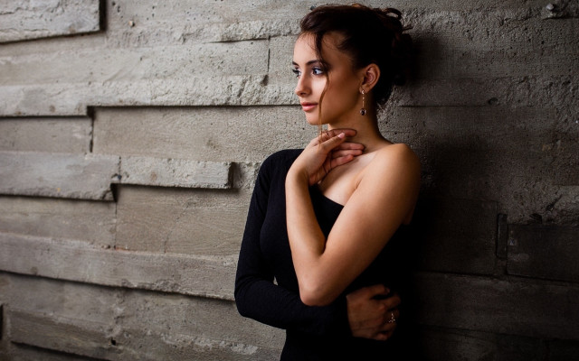 Woman leaning wall serious portrait #4 free wallpaper - medium preview image