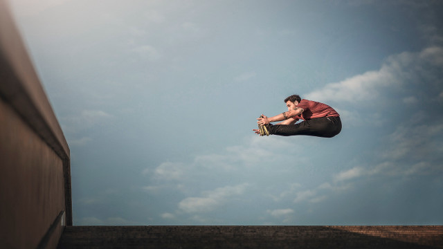 Man flying skateboard ramp building free wallpaper - medium preview image