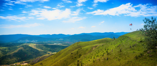 Kite flying grassy hill mountains #2 free wallpaper - medium preview image