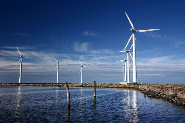 Wind turbines water rocks sky free wallpaper - medium preview image