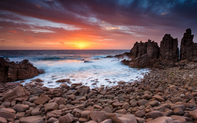 Rocky beach wave sunset cityscape free wallpaper - medium preview image