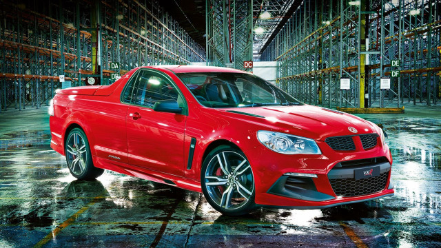 Red car warehouse pallets cityscape free wallpaper - medium preview image