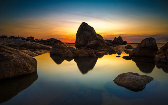 Sunset water rocks building sky free wallpaper - medium preview image