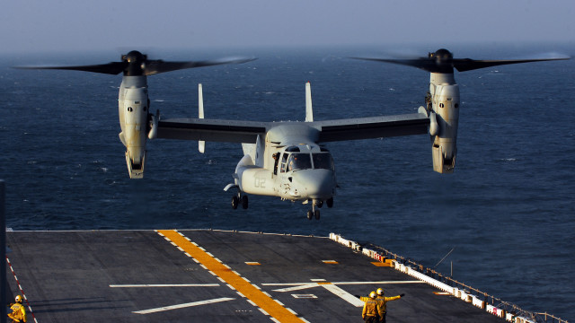 Large airplane flying over ship free wallpaper - medium preview image
