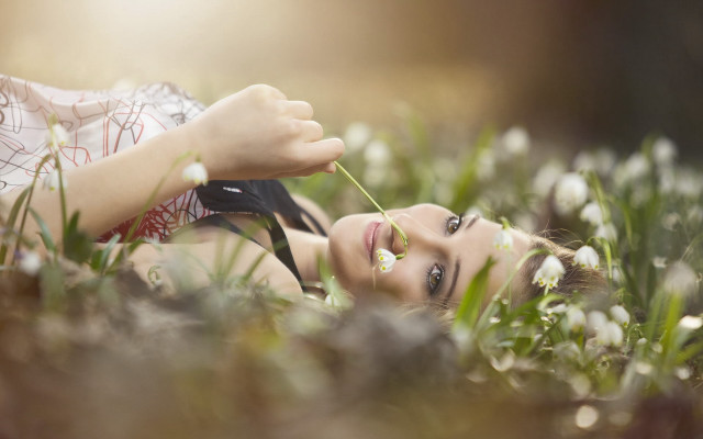 Woman laying grass flower mouth free wallpaper - medium preview image