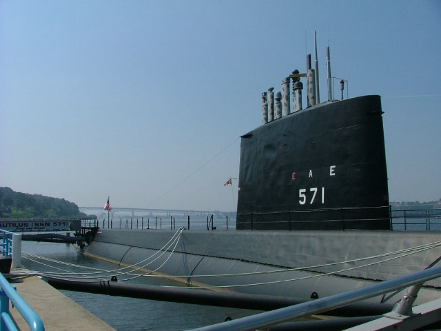 Large black ship docked pier free wallpaper - medium preview image