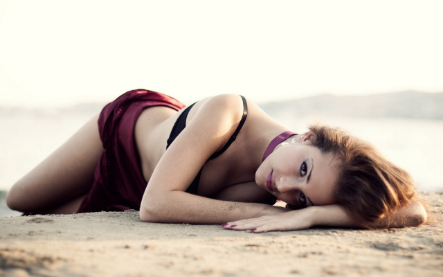 Beach bikini woman laying sand free wallpaper - medium preview image