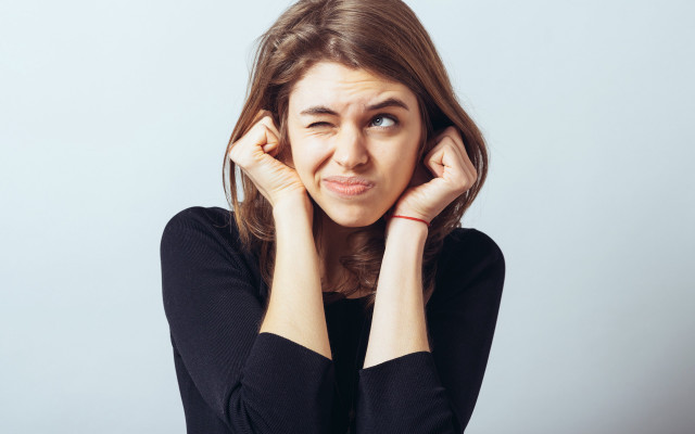 Surprised woman hands to ears free wallpaper - medium preview image