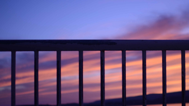 Sunset balcony fence bench pink free wallpaper - medium preview image