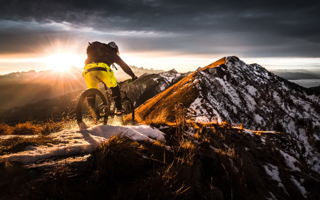 Man bike snow sunset mountains free wallpaper - medium preview image