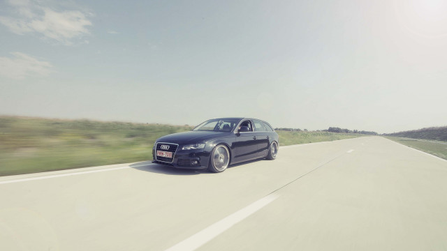 Black car driving road grass #2 free wallpaper for desktop - medium preview image
