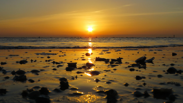 Sunset ocean beach rocks boat free wallpaper - medium preview image