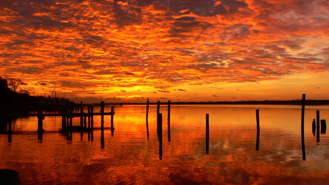 Sunset water dock poles mountains free wallpaper - medium preview image