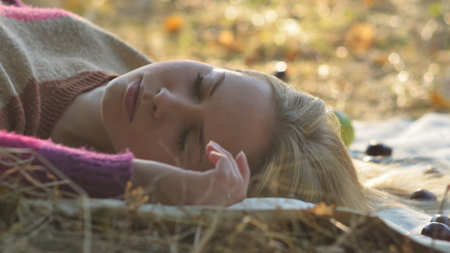 Woman lying in grass blurry free wallpaper - medium preview image
