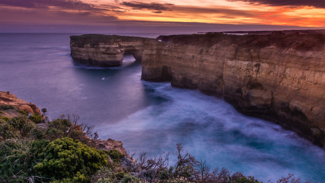 Sunset rocky cliff water bush free wallpaper - medium preview image