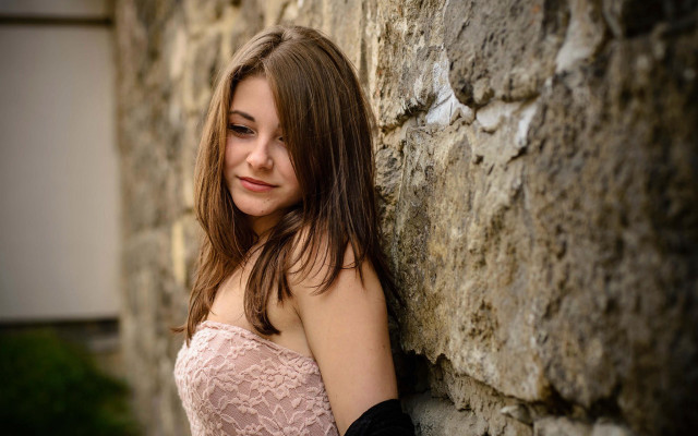 Woman leaning stone wall cosplay free wallpaper - medium preview image