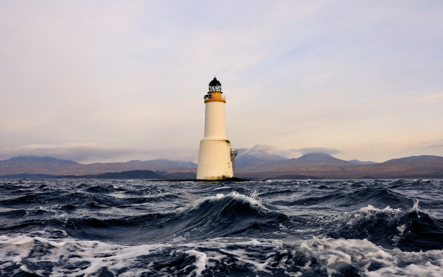 Lighthouse ocean mountains waves sunset free wallpaper for desktop - medium preview image