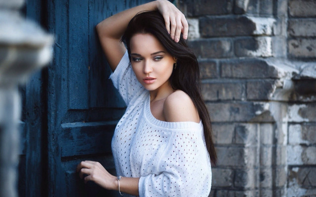Woman white top brick wall free wallpaper - medium preview image