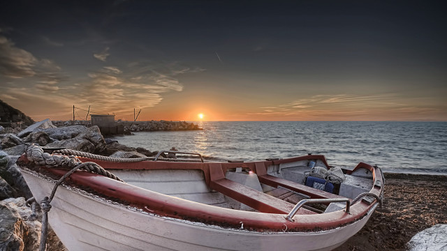 Sunset beach boat rocky shoreline free wallpaper - medium preview image