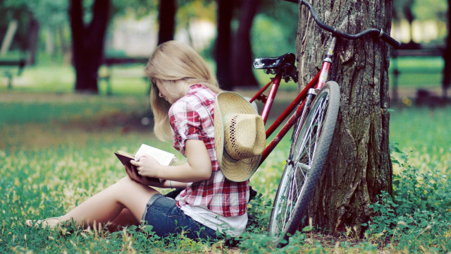Girl bicycle reading tree grass free wallpaper - medium preview image