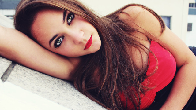 Woman longhair redshirt lying ledge free wallpaper - medium preview image