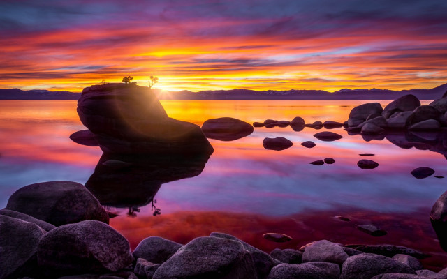Sunset lake rocks water person free wallpaper - medium preview image