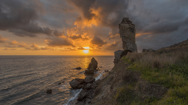 Sunset rocky cliff grassy hill free wallpaper - medium preview image