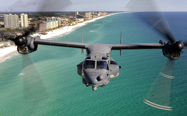 Military plane beach ocean buildings free wallpaper - medium preview image