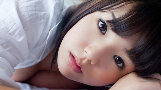 Young girl laying bed hands free wallpaper - medium preview image