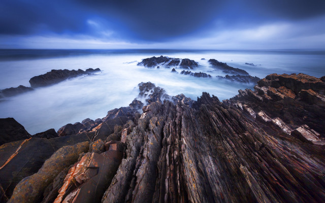 Rocky shore water mountains sky free wallpaper - medium preview image
