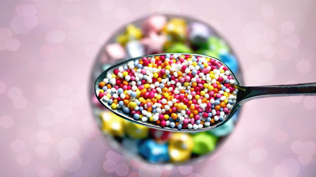 Spoon candy sprinkles pink background free wallpaper - medium preview image