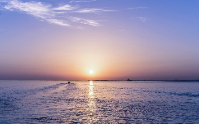Boat sunset distant mountains ocean free wallpaper - medium preview image