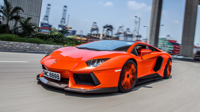 Bright orange sports car city #2 free wallpaper - medium preview image