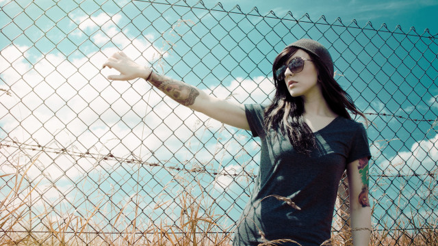 Woman hat sunglasses fence outstretched free wallpaper - medium preview image