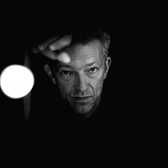 Man looking camera dark light free wallpaper - medium preview image