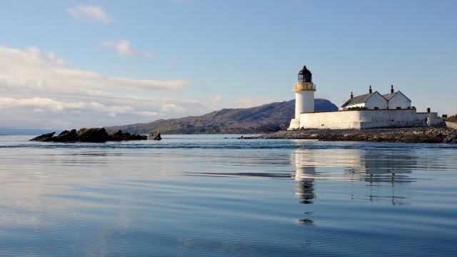 Lighthouse rocky shore mountains water free wallpaper - medium preview image