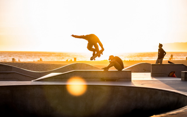 Skateboarder flying sunset beach ocean free wallpaper - medium preview image