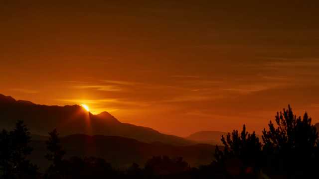 Sunset mountains trees clouds orange free wallpaper - medium preview image