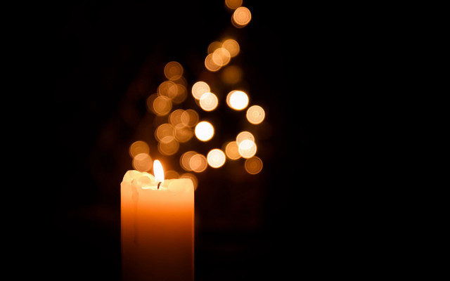 Lit candle blurry lights dark free wallpaper - medium preview image