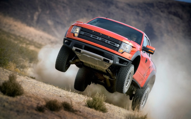 Red truck jumping hill dust free wallpaper - medium preview image