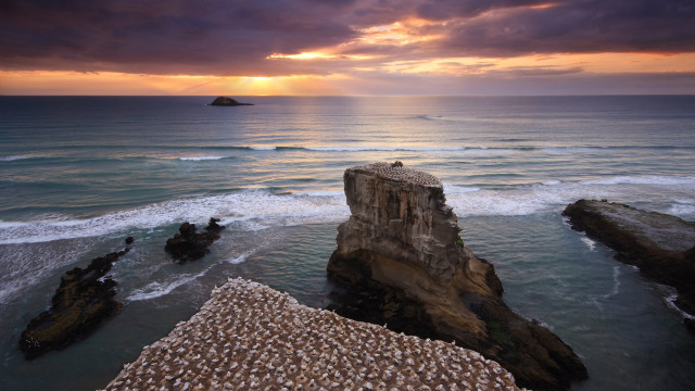 Sunset ocean rock formation island free wallpaper - medium preview image